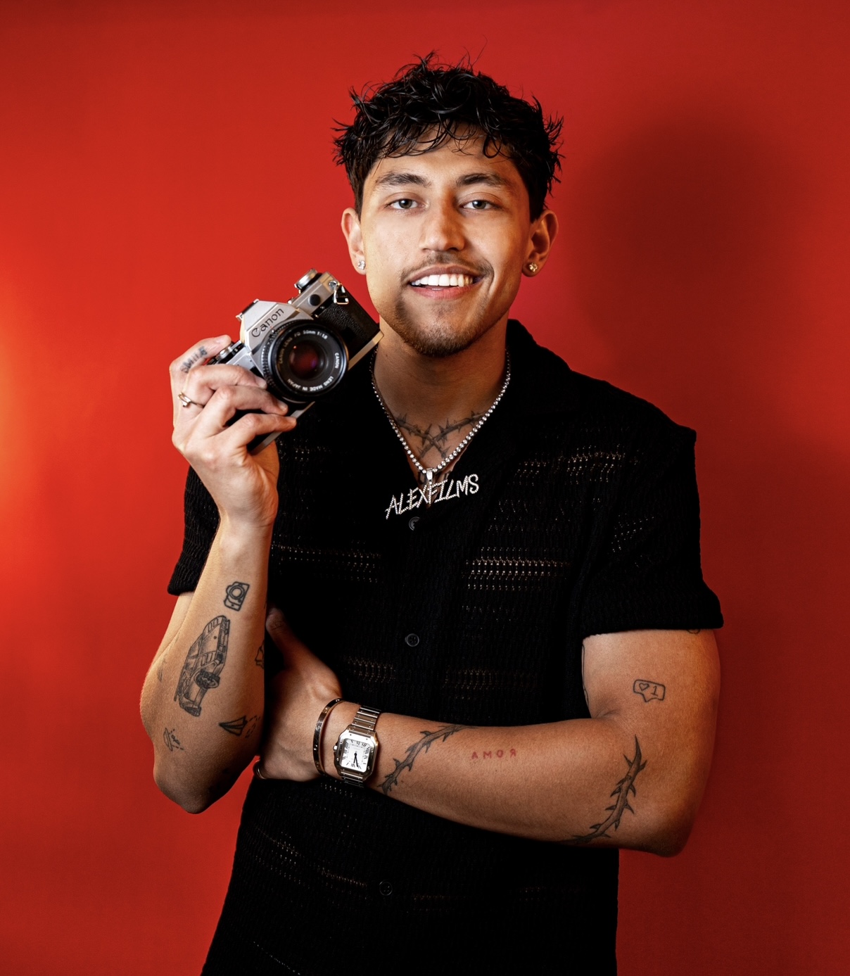 Alex Films, Creative Director of Sabor Studios, holding a Canon film camera